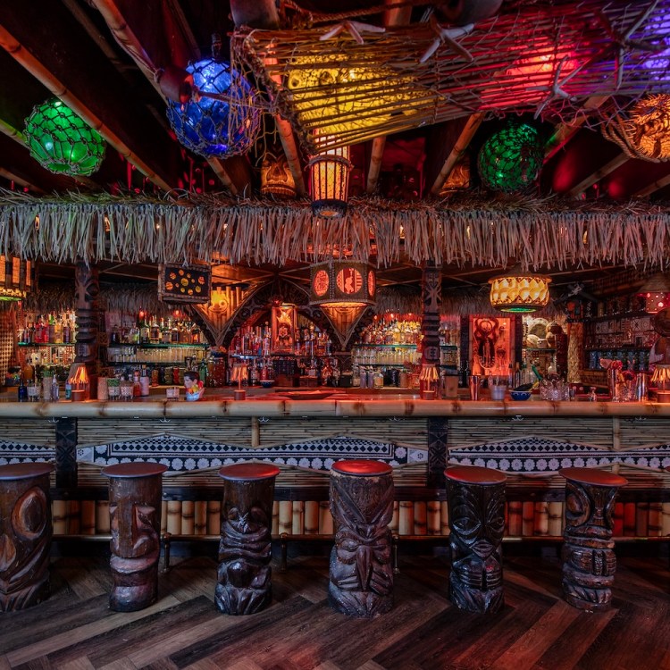 Interior of Lucky Tiki, decorated in bamboo decor and colorful lighting