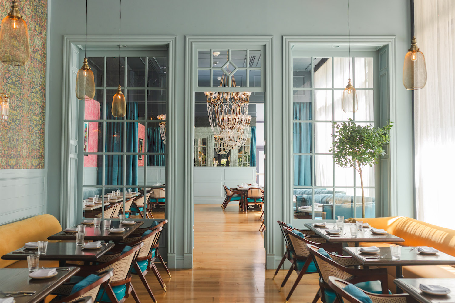 Baar Baar's Victorian-inspired dining room features Indian touches and a statement fuchsia backdrop