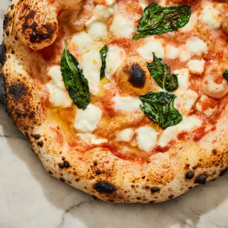 A Margherita pizza on a marble surface