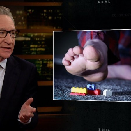 Bill Maher talks as a foot steps on a Lego