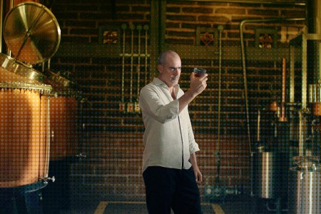 Iván Saldaña of Casa Lumbre inspecting a glass near a still