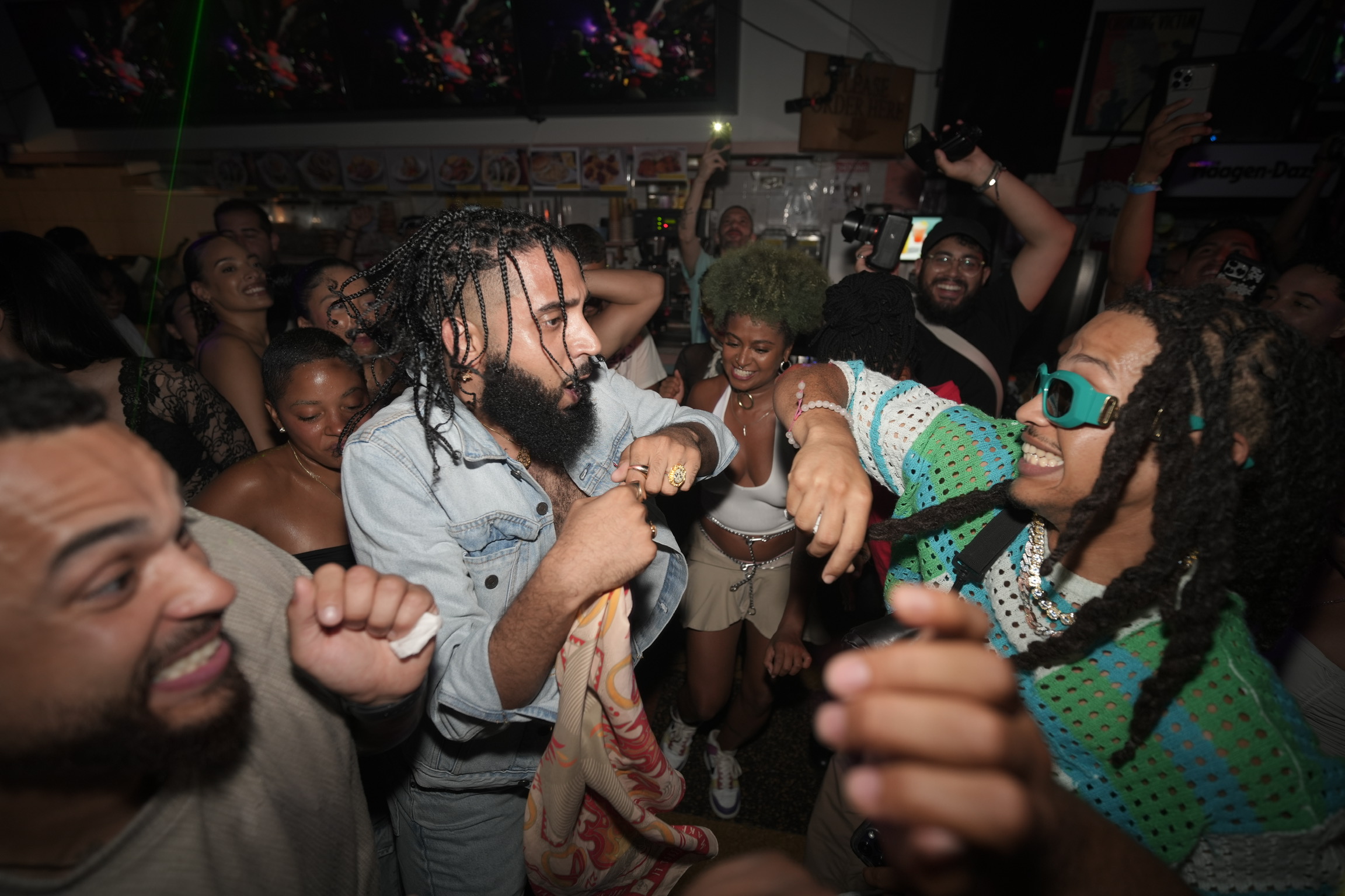 People dancing at the bodega party.