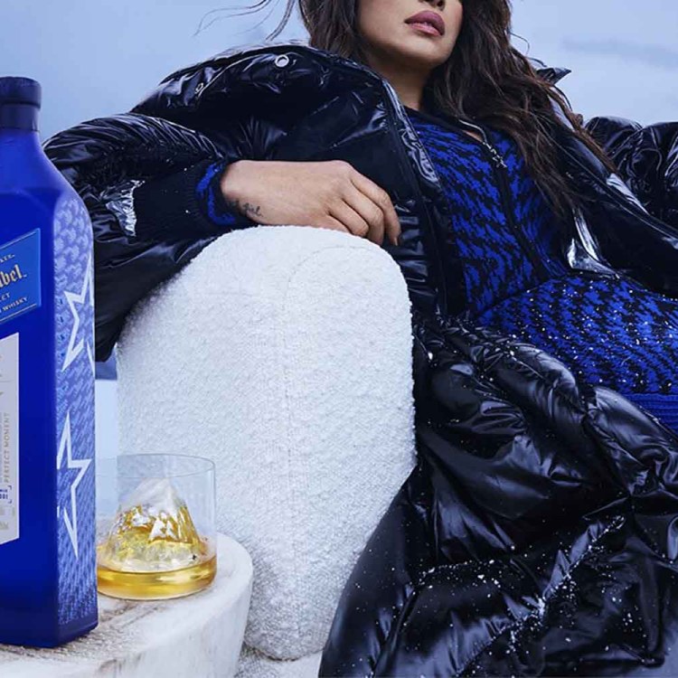 Priyanka Chopra Jonas sitting near a bottle of Johnnie Walker Blue Label Ice Chalet