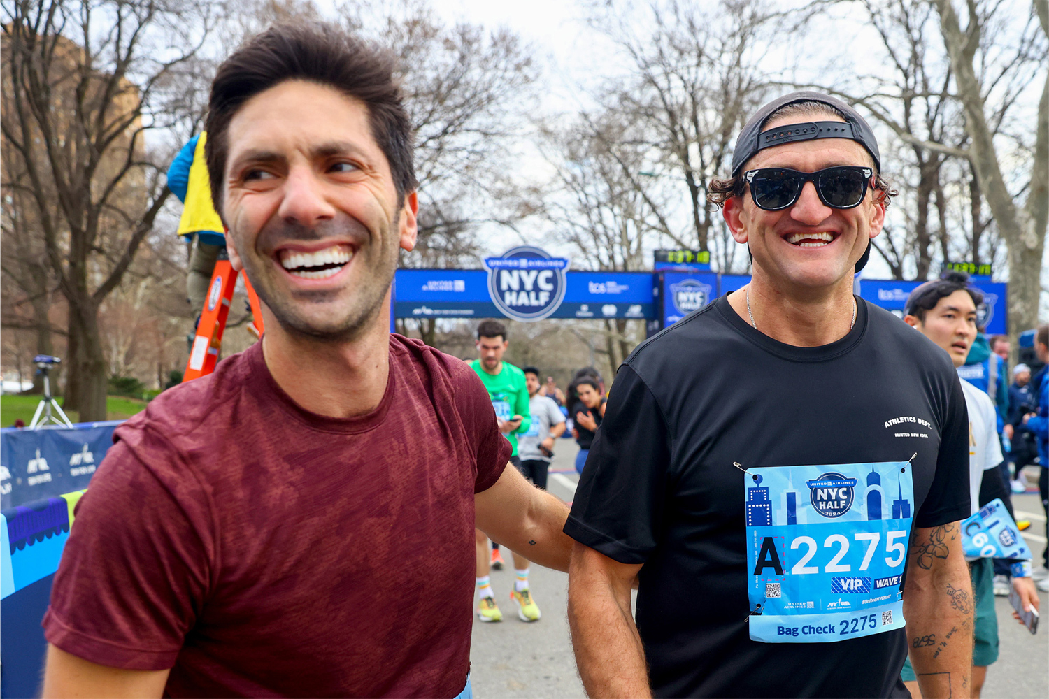 Schulman grinning with his friend Casey Neistat after the NYC Half.