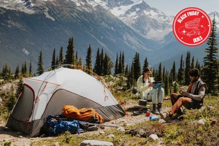 Two people camping near a mountain.