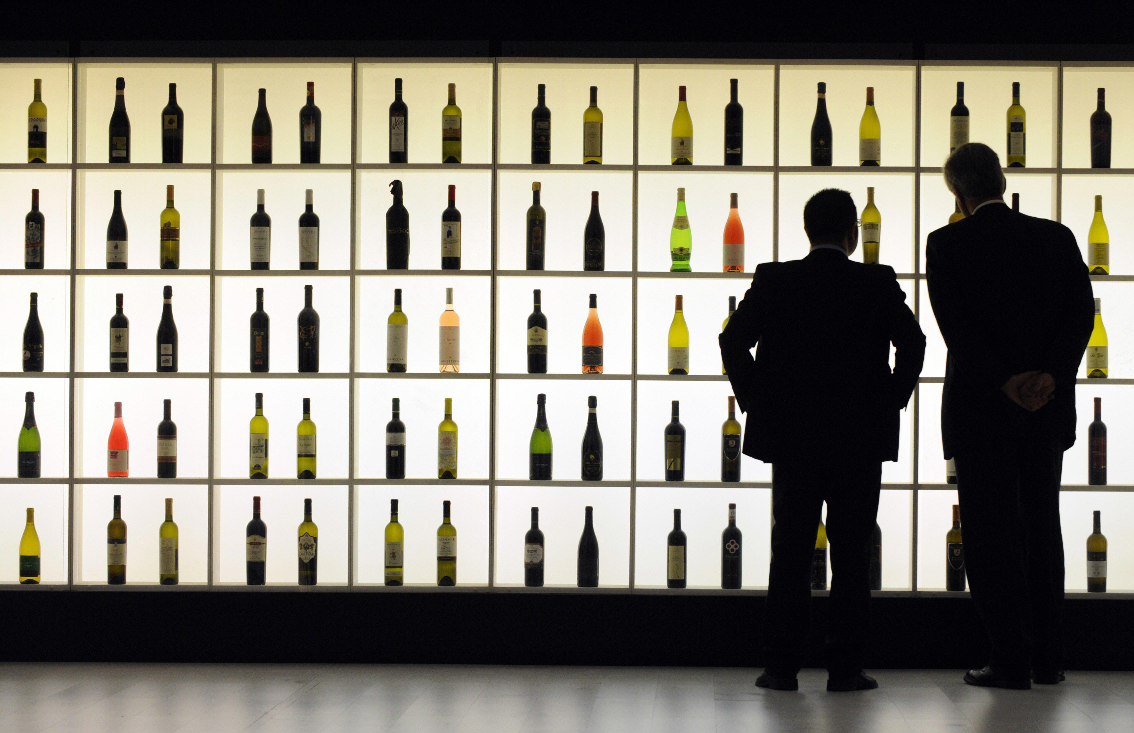 Wine buyers look at bottles during Vinitaly in Verona.