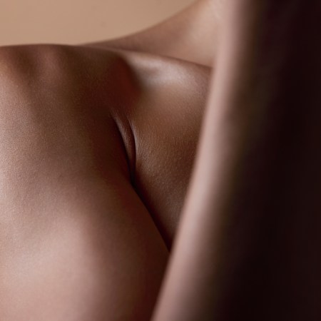 Healthy, skin and body closeup on black woman, shoulder or natural glow from skincare in studio with cosmetics.