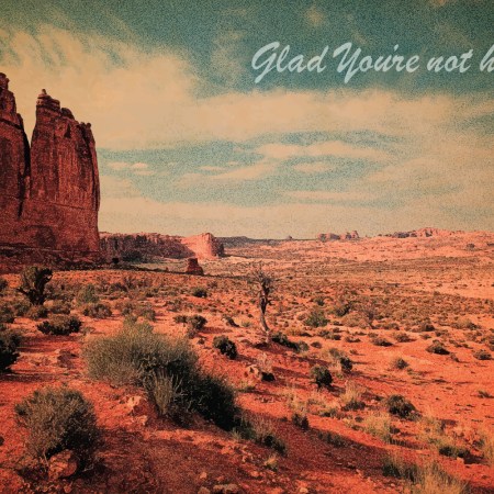 a vintage desert postcard that says glad you're not here