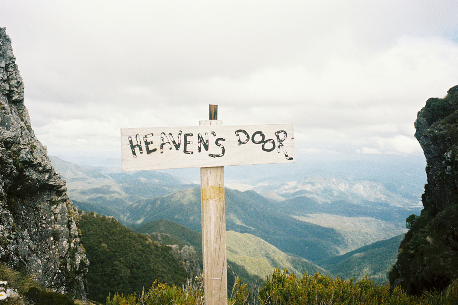 A sign that reads "HEAVEN'S DOOR" in all caps.