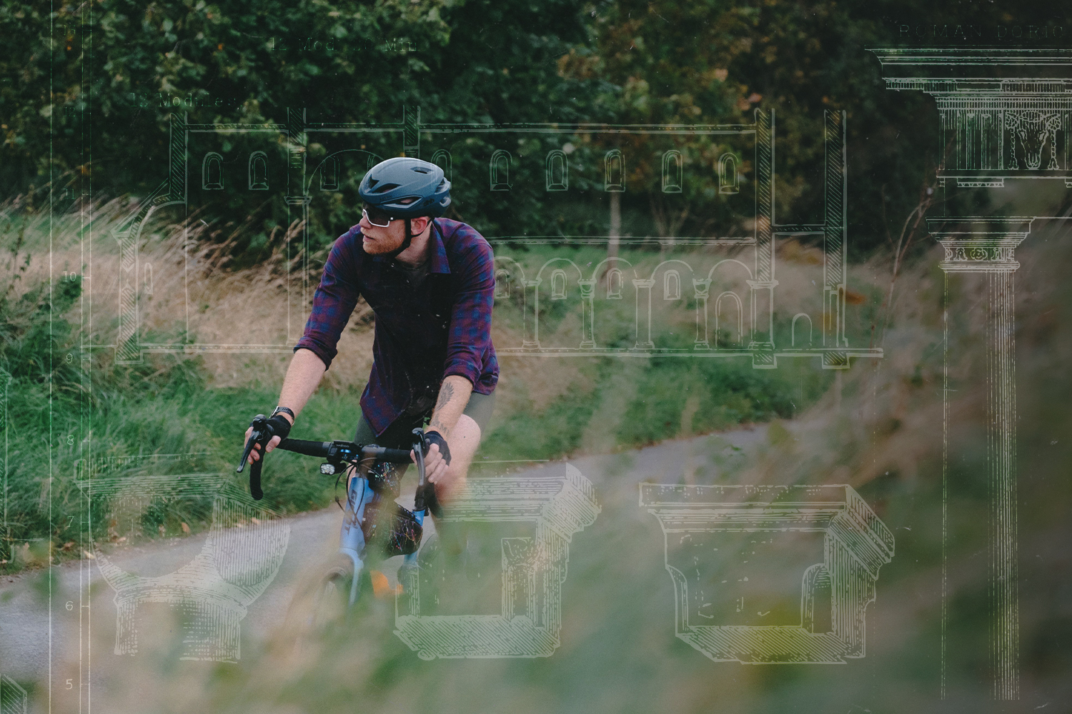 Guy Stapleford rides his bike on a country lane. Light sketches of Roman columns adorn the photo.