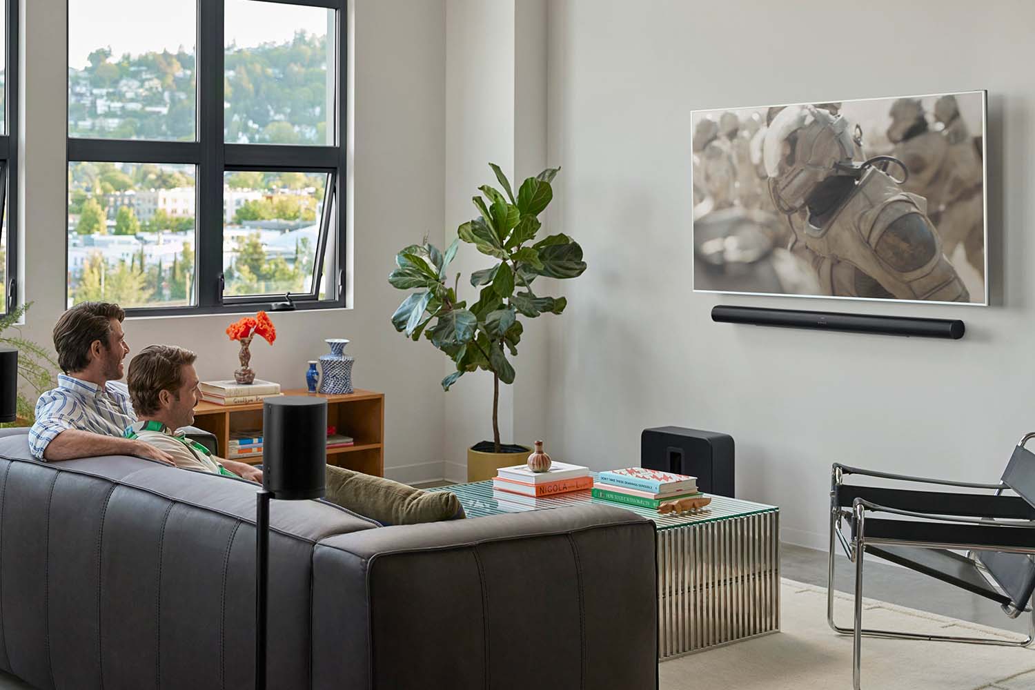 Sonos Arc Ultra and Sub 4 in a living room with a couple watching TV